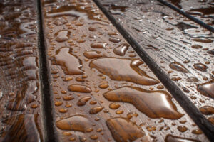 Wooden table wet from the rain with waterdrops